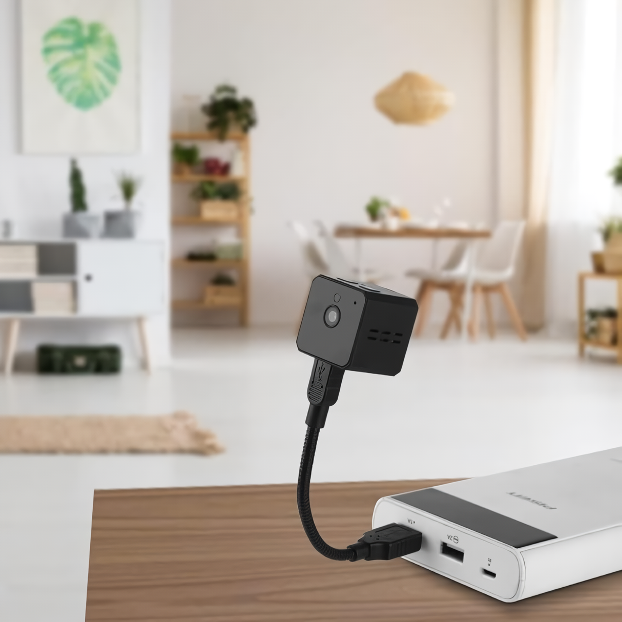 SpyWfi mini travel Cube Camera plugged into a power bank via a USB cable