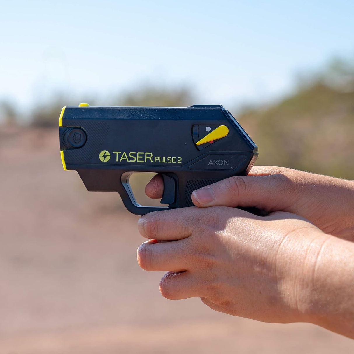 Hand gripping and pointing a TASER Pulse 2 Reloadable Shooting Stun Gun