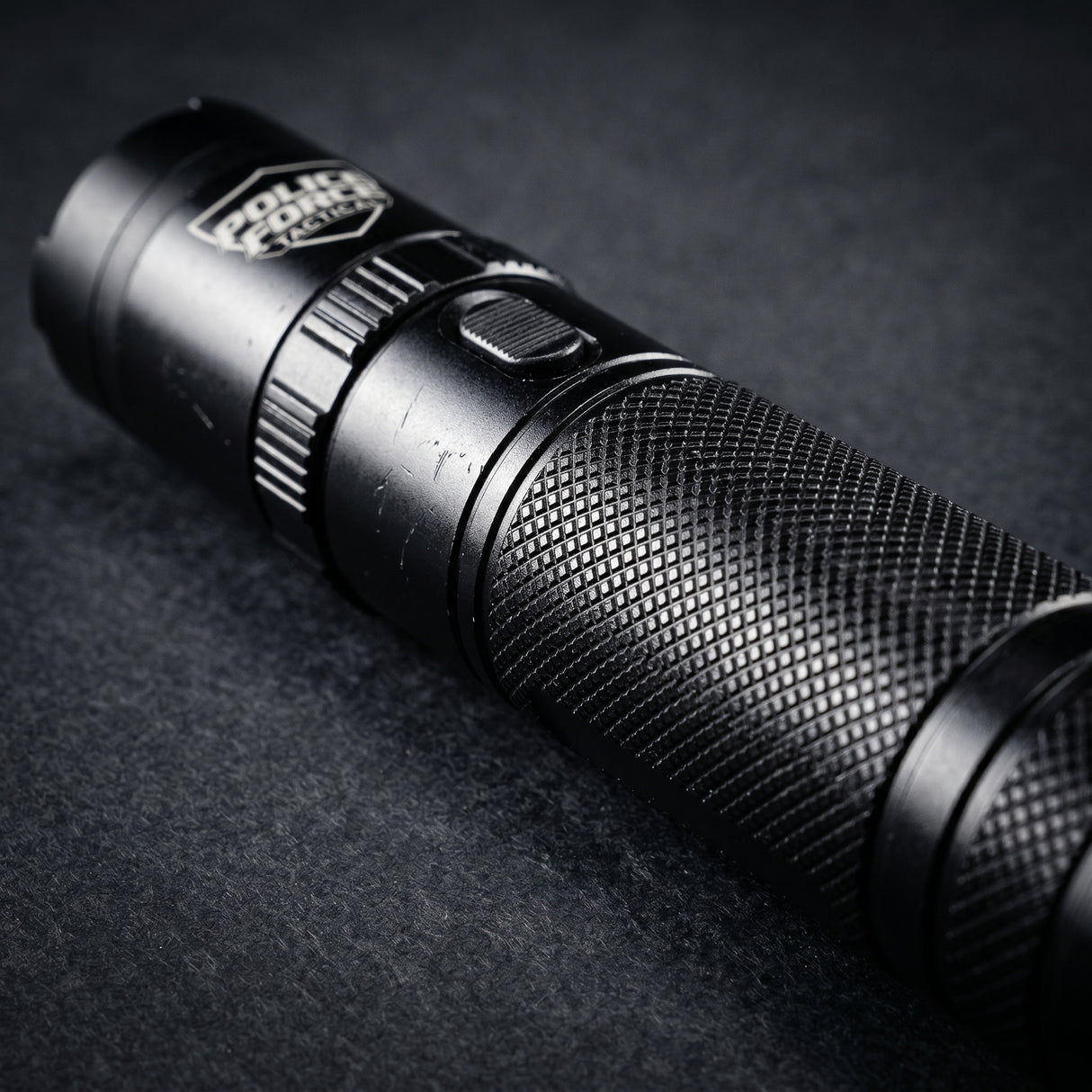 A close up view of Police Force Tactical Rechargeable Stun Gun Flashlight 9.2M highlighting its metal prongs