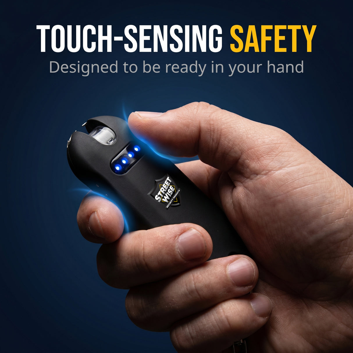 Hand holding a black touch-sensing safety device with text on a dark background