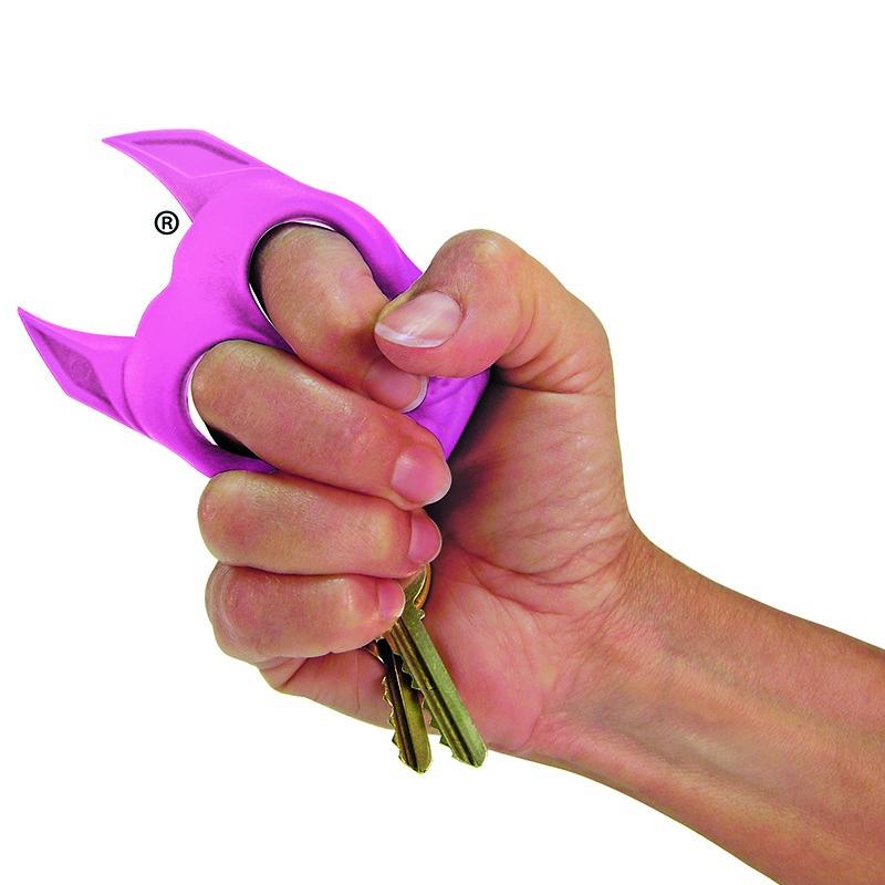 A hand gripping a Pink Brutus Bulldog Keychain Weapon