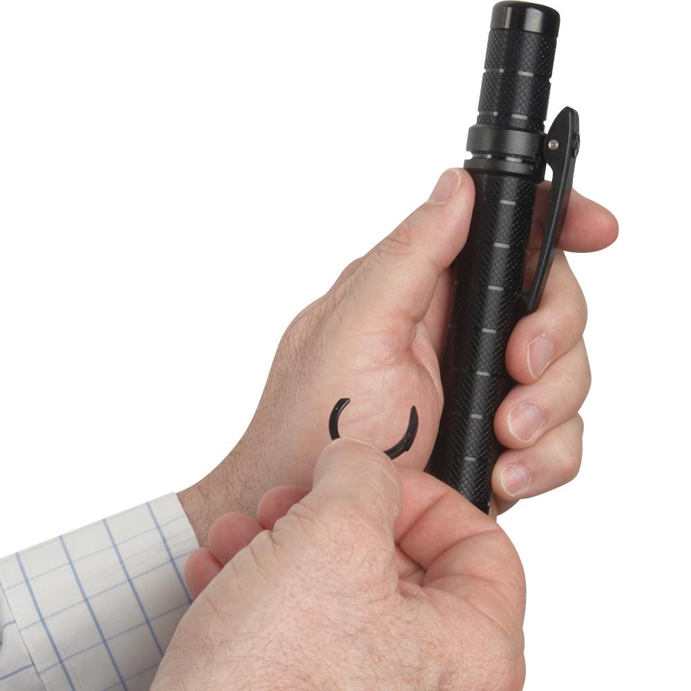 A hand holding a removed clip of ASP Protector Friction Loc Expandable Clip-On Baton