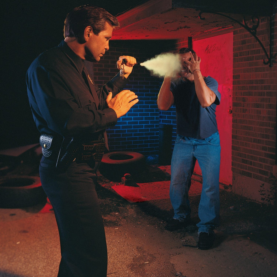 policeman using ASP® Key Defender Keychain Pepper Spray Baton