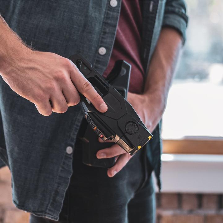 Hand drawing a BLACKHAWK! TASER X1/X26P from a Quick Draw Holster