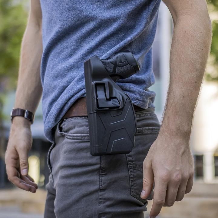 BLACKHAWK! TASER X2 carried in a Quick Draw Holster on a person's belt.