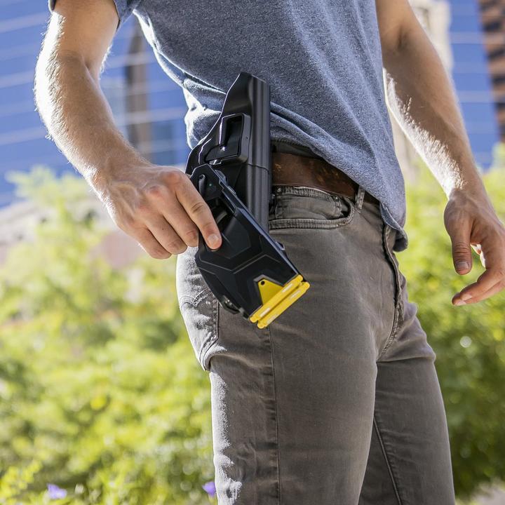 Hand drawing a BLACKHAWK! TASER X2 from a belt Quick Draw Holster