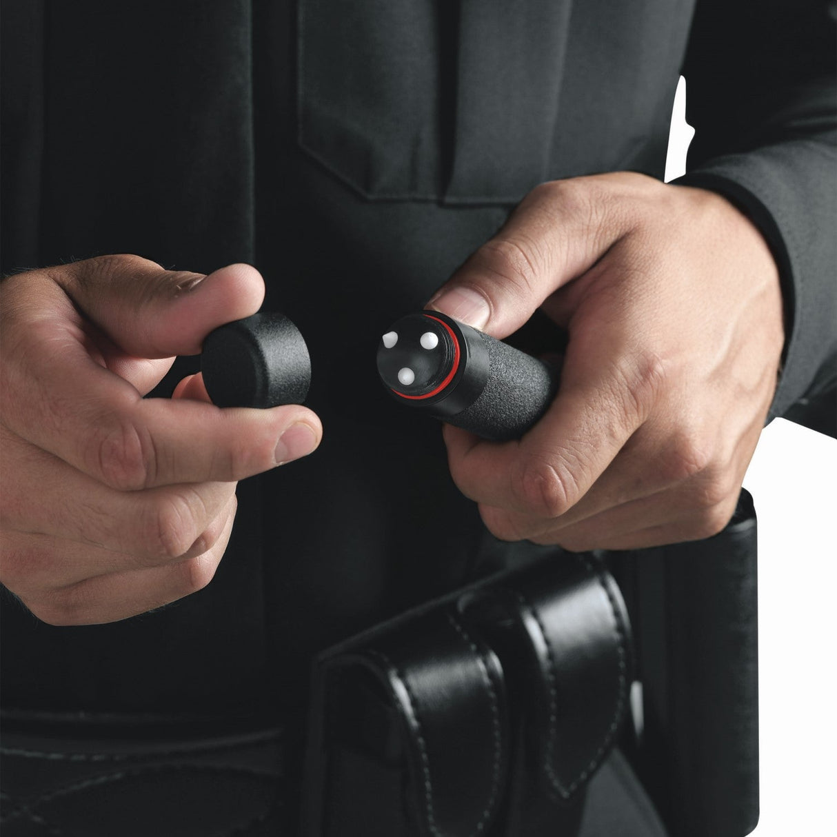 A person removing the cap of an ASP BreakAway Baton Subcap Replacement F Series