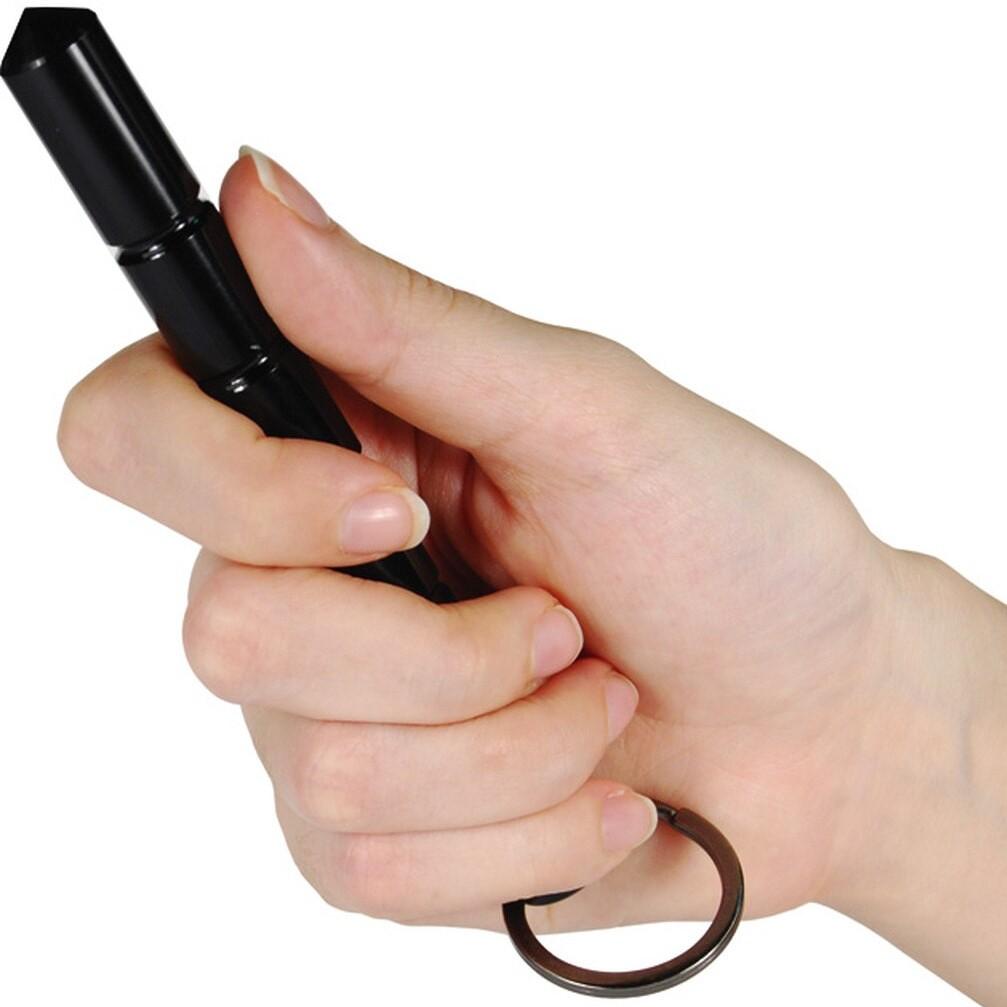 Hand holding a 5.5" Black Tactical Pointed Tip Aircraft Aluminum Kubotan from WeaponTek