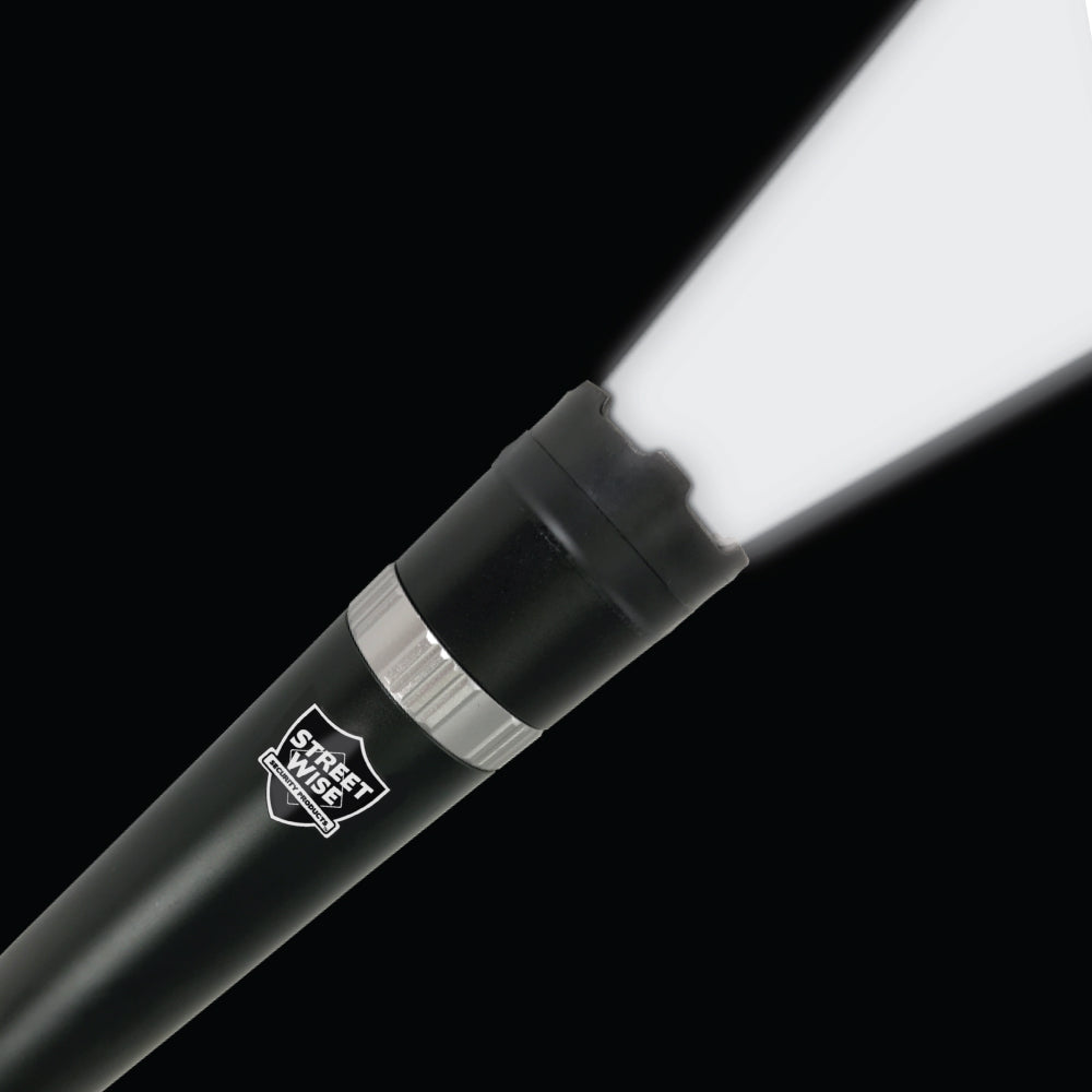 the Streetwise Triple Defender 17.5" LED Stun Gun Baton 27M with the flashlight on in a dark background.