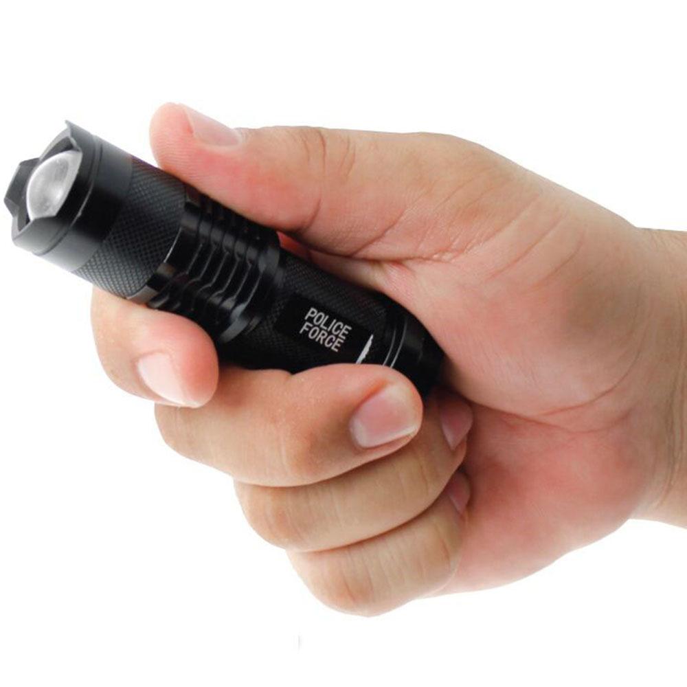 Police Force Tactical Mini Slide Zoom Flashlight in hand
