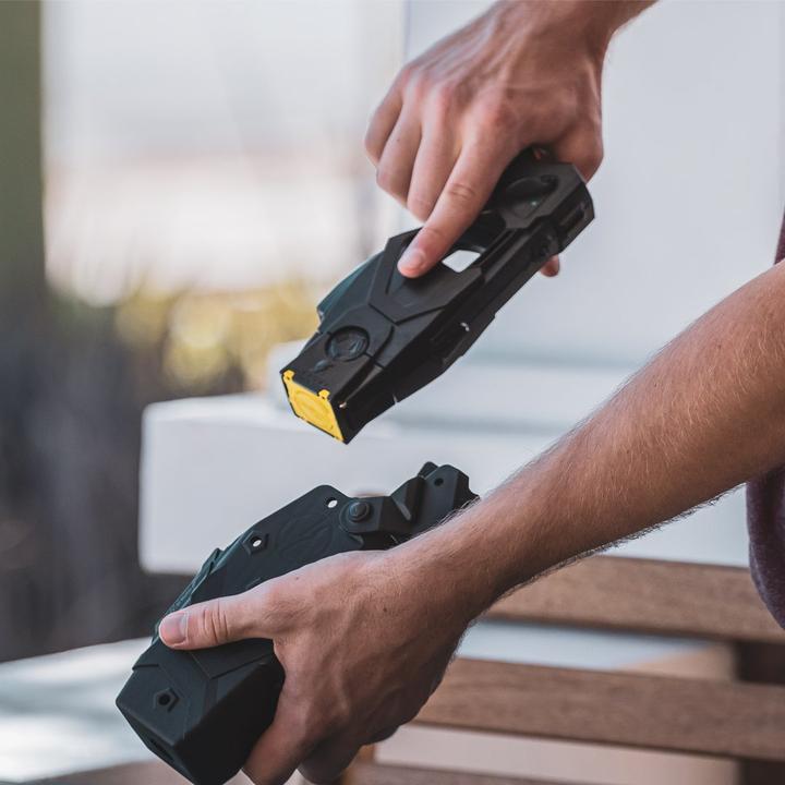 Hands drawing a BLACKHAWK! TASER X1/X26P from Quick Draw Holster