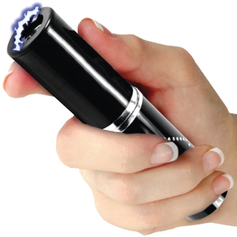 Black stun gun disguised as a perfume or lipstick tube held in hand