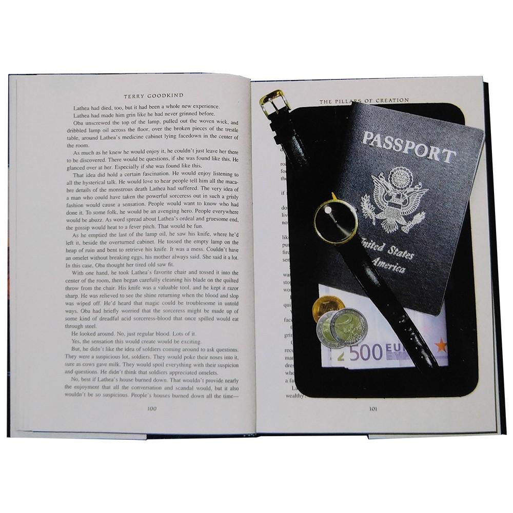 An open hardbound book, revealing a hidden black diversion safe inside that contains important belongings