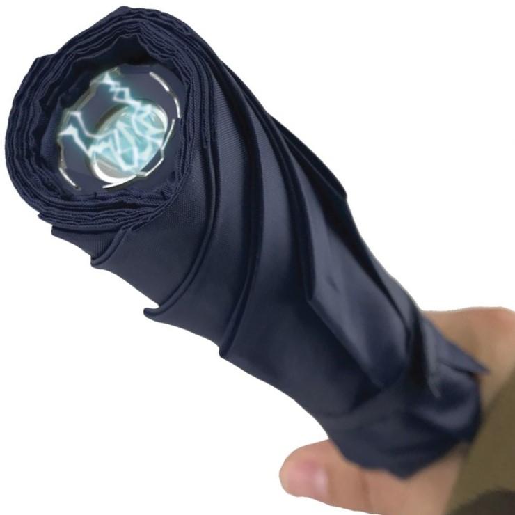a hand holding a Streetwise™ Stunbrella Stun Gun Flashlight 32M Blue up close to its stun metal prongs and LED flashlight