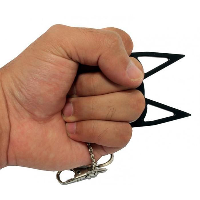 a hand gripping a black WeaponTek Cat Keychain Self-Defense Metal Knuckle Weapon