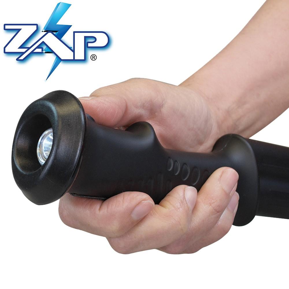 a hand holding aZAP Hike 'n Strike™ LED Stun Gun Staff using the LED light by the handle
