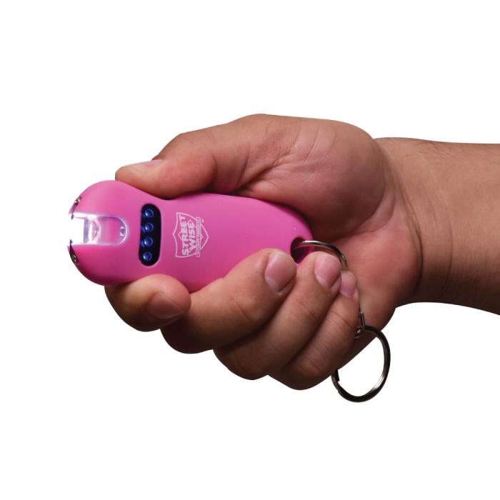 hand holding a pink Street Wise mini stun gun with flashlight