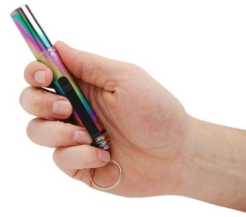 Hand gripping a compact, fully collapsed multi-colored 12" Safety Tech Expandable Steel Keychain Baton fully extended