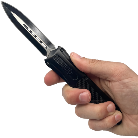 A hand holding an open 3.25" Armed Force Tactical OTF Dagger Knife