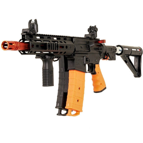 A Byrna Mission-4 Bundle Non-Lethal Pepper Projectile rifle with an orange grip and black body, equipped with a scope and a magazine.