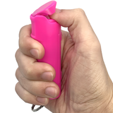 A hand pressed into a Streetwise™ Police Strength Sticky Gel Pepper Spray Keychain 1/2 oz.