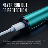 Teal Streetwise Pain Pen connected to a charging cable. 