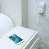 Spywifi Night Light USB Plug Adapter Hidden Spy Camera plugged into a wall outlet charging a smartphone