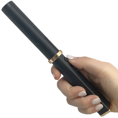 A hand holding a Streetwise Hair Fryer Brush Disguised Rechargeable Stun Gun with head removed