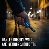 Hand holding a Streetwise Pain Pen on a city street with text 'Danger doesn't wait and neither should you'.