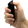 A hand pressing a Streetwise Police Strength Sticky Gel Pepper Spray 1/2 oz.