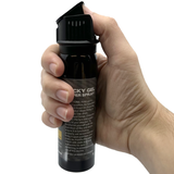 A hand pressing a Streetwise Police Strength Sticky Gel Pepper Spray 4 oz.