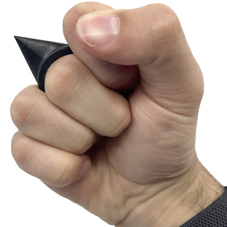 a hand gripping a black Streetwise SHAR-KEY Tooth Self Defense Keychain Weapon