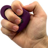 a hand gripping a dark purple Streetwise Sting Ring Rechargeable Stun Gun 18M.