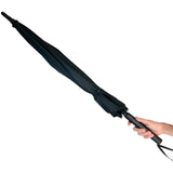 a hand holding a black Streetwise Tactical Stunbrella Disguised Rechargeable Stun Gun.