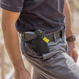 a photo of a TASER Pulse Nylon Holster w/ Adjustable Metal Belt Clip attached to a belt