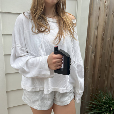 a woman holding The Stunner 3-in-1 Rechargeable LED Stun Gun Pepper Spray Jogger Combo