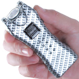 a hand holding a black and white patterned Tiger-USA Xtreme® Mighty Warrior LED Stun Gun 1