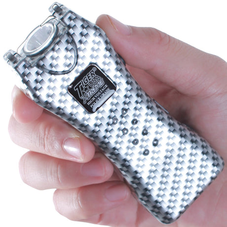 a hand holding a black and white patterned Tiger-USA Xtreme® Mighty Warrior LED Stun Gun 1