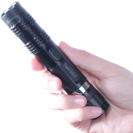 a hand holding a Tiger-USA Xtreme SHOCKDROP Stun Gun Flashlight 100M