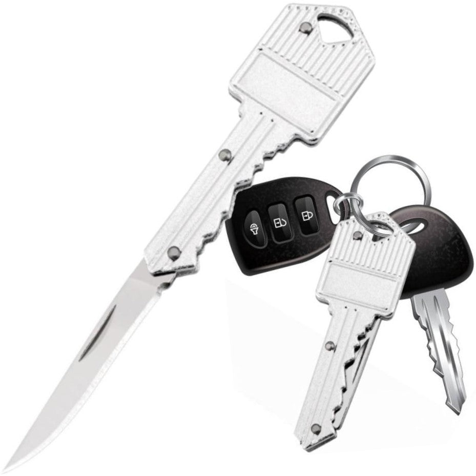 A silver WeaponTek Fake House Key Concealed EDC Folding Pocket Knife designed to look like a house key, displayed alongside actual keys and a key fob.