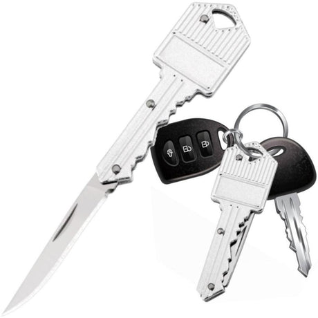 A silver WeaponTek Fake House Key Concealed EDC Folding Pocket Knife designed to look like a house key, displayed alongside actual keys and a key fob.