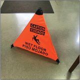 a Wet Floor Sign English/Spanish 18' Orange with Hang Tube placed on the floor