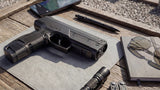 black byrna launcher on wooden table