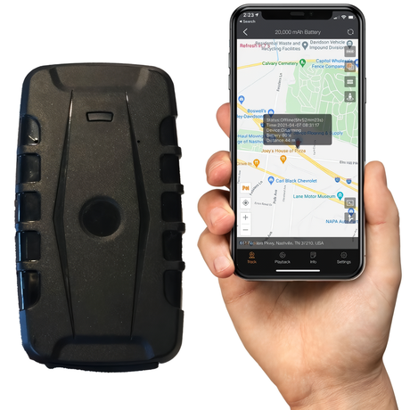Black iTrail Endurance Rechargeable Long Life 4G GPS Tracker and a hand holding a smartphone with the iTrail app running
