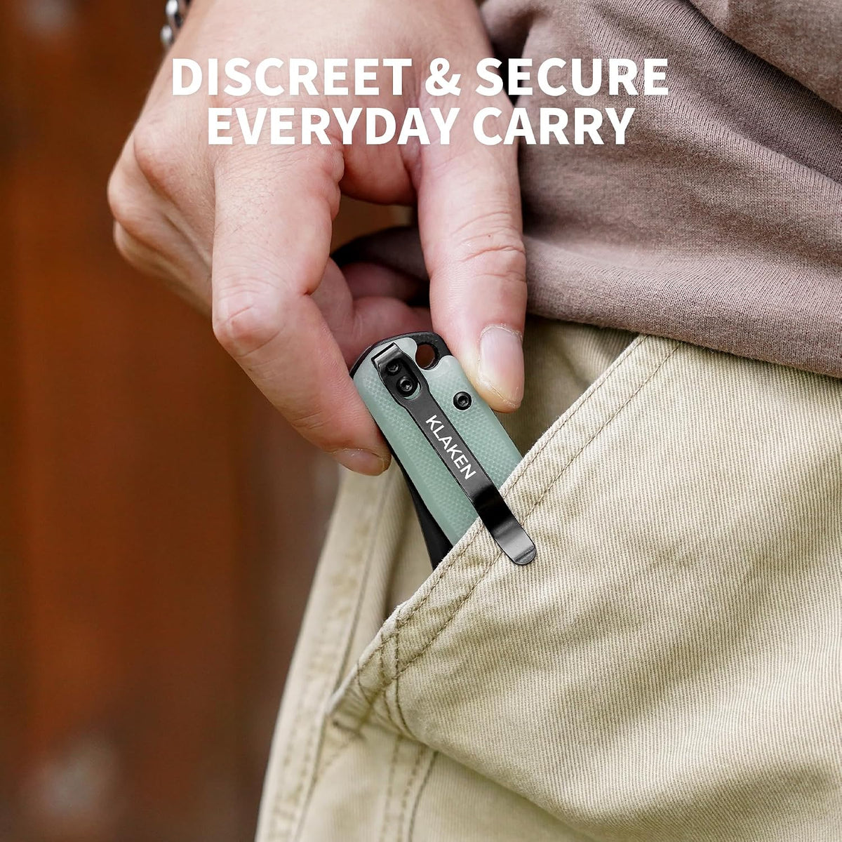 A close-up of a hand inserting a small Klaven clip phone case into a beige pocket, with a brown shirt and the text 'DISCREET & SECURE EVERYDAY CARRY' overlaid at the top.
