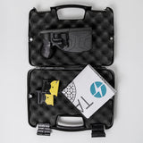 Complete TASER X2 kit with case, two cartridges, user manual, and protective foam interior