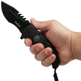 Hand holding an open Black 3.5" folding stainless steel pocket knife with paracord by Elite Edge