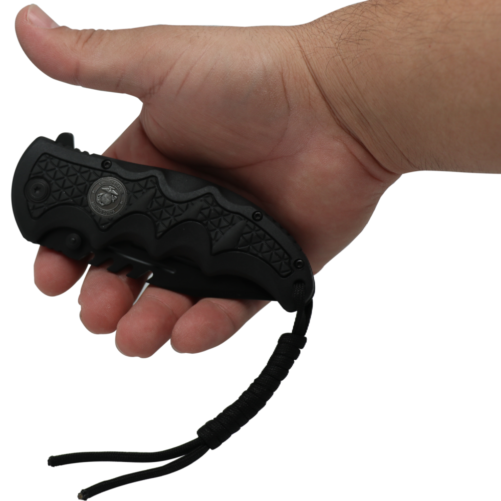 Hand holding a closed Black 3.5" folding stainless steel pocket knife with paracord by Elite Edge