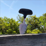 3.5 inch Tactical Steel Neck Knife from ElitEdge stuck into a wooden fence outdoors