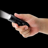 A hand holding 3.5" Police Force Tactical Mini Q5 LED Zoom Flashlight 220 Lm powered on